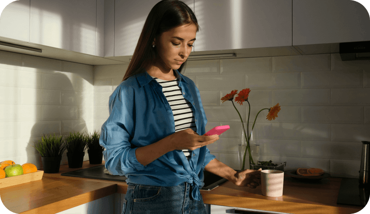 A therapist looks at her mobile phone and wonders about the benefits of enabling her clients to use online booking to schedule appointments with her