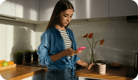 A therapist looks at her mobile phone and wonders about the benefits of enabling her clients to use online booking to schedule appointments with her