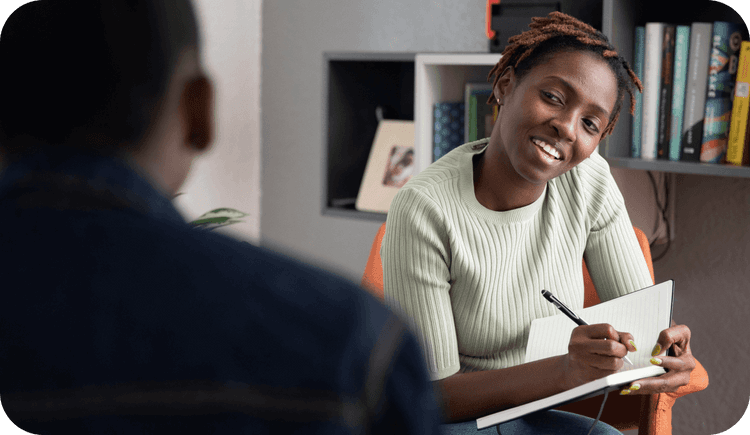A therapist meets with her male client and writes in her notebook as she considers countertransference in therapy
