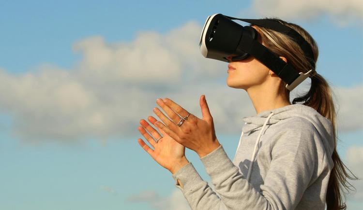 A woman uses VR, which is similar to the process of prolonged exposure therapy since both involve simulating a situation you're not currently in. Prolonged exposure therapy involves reliving or recalling traumatic moments or triggers to heal.