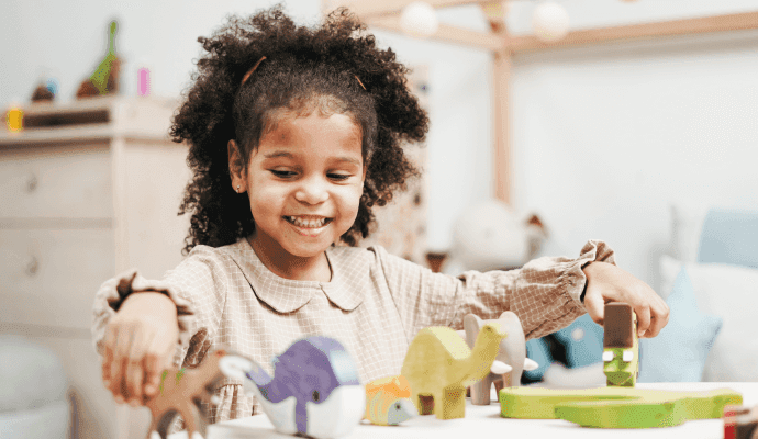 A child plays with toys in a play therapy room that was designed specifically for play therapy sessions using these guidelines and tips.