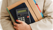 A female therapists holds onto her calculator and bookkeeping ledger