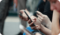 A therapy client is on her mobile phone and thinking about the issues between social media and mental health