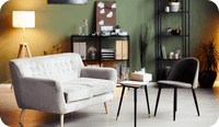 A gray modern couch and small side tables as well as a credenza are seen in a photograph of a modern therapy office with a gray rug as part of therapist design tips offered.