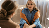 A therapist and her client are face to face, in a therapy session. The therapist is utilizing a technique found in this list of therapeutic interventions.