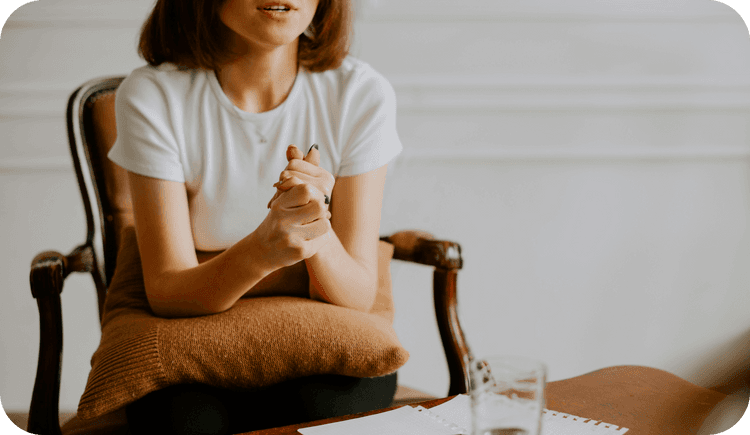 A client holds her hands together tightly as she makes a connection between her own experiences and her projections in therapy, using her awareness of transference to garner insight. This article explains transference psychology to therapists, and how they can use transference awareness to facilitate therapy.