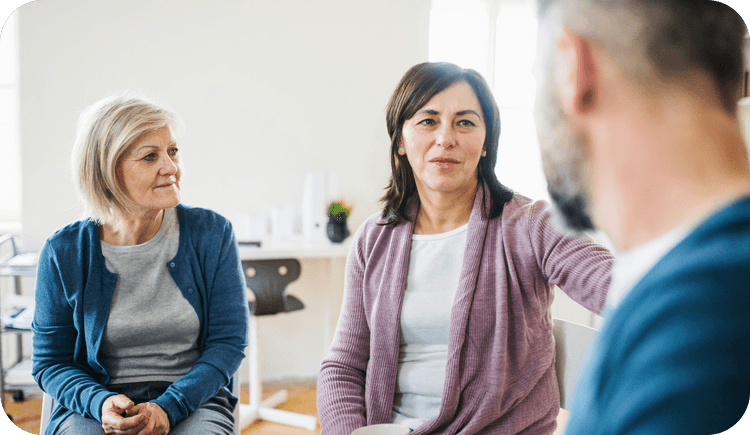 A female therapist discusses systemic family therapy with her clients
