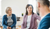 A female therapist discusses systemic family therapy with her clients