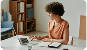 A female therapist looks at the top 10 therapist websites on her laptop computer