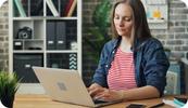 A therapist works at her laptop computer to look up the most common CPT codes