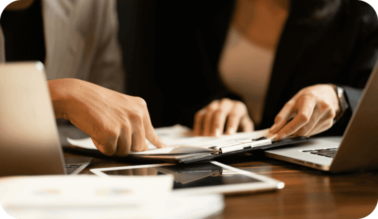 A therapist holds insurance claims and wonders how to prevent mental health insurance claim denials