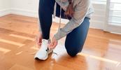 female lacing up shoes underscoring benefits of movement for virtual practitioners