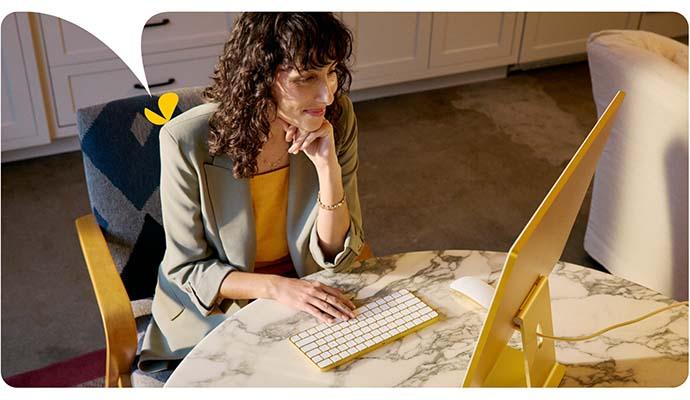 A female therapist types on her computer keyboard as she accesses her AI for therapists session notes