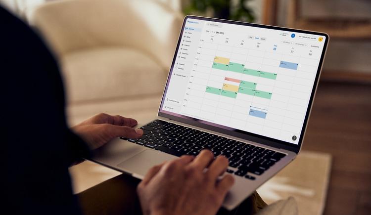 A clinician on a laptop listing the four types of administrative functions in the EHR that are must-have functionalities