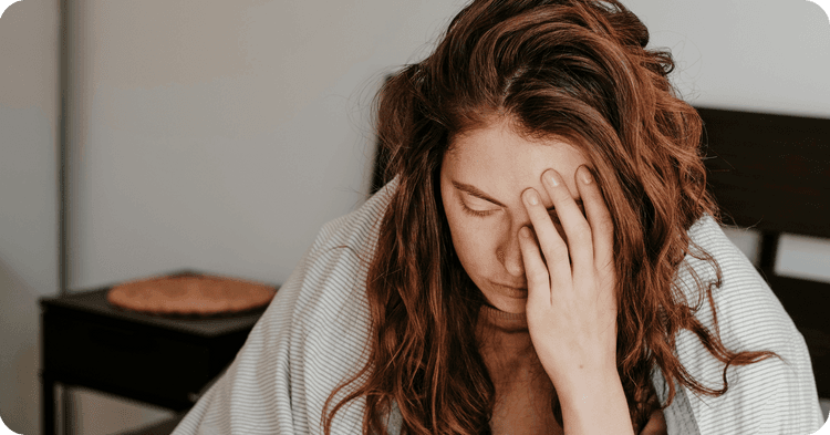 A client struggling through symptoms of bipolar psychosis put's heir head in their hand, out of frustration. Find out how to identify and distinguish bipolar psychosis, or bipolar with psychotic features, so you can better evaluate your patients.