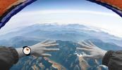 A person is parachuting down over a vista of mountains.