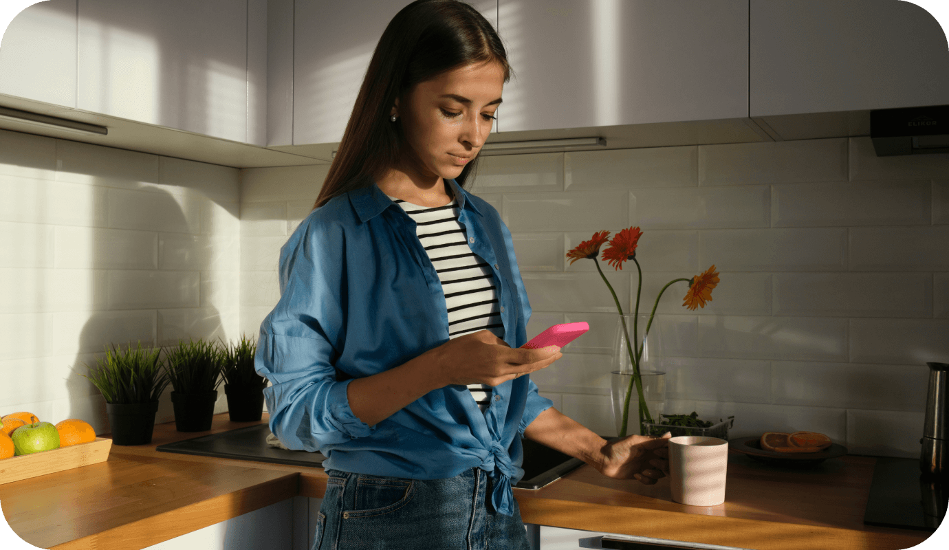 A therapist looks at her mobile phone and wonders about the benefits of enabling her clients to use online booking to schedule appointments with her