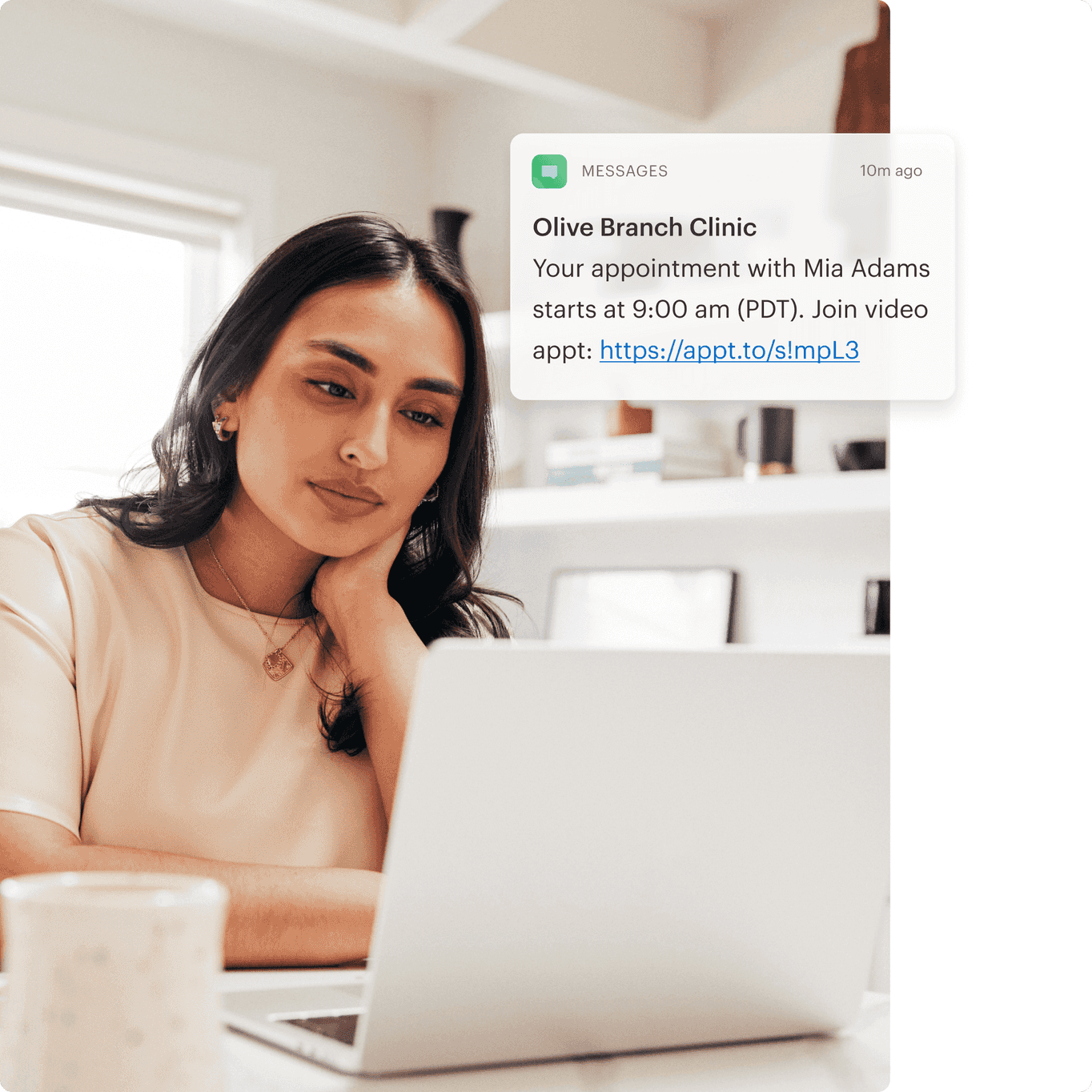 Female occupational therapist reading an appointment reminder message on her laptop