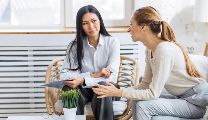 A therapist goes to therapy for herself, she sits next to her therapist who is listening intently.