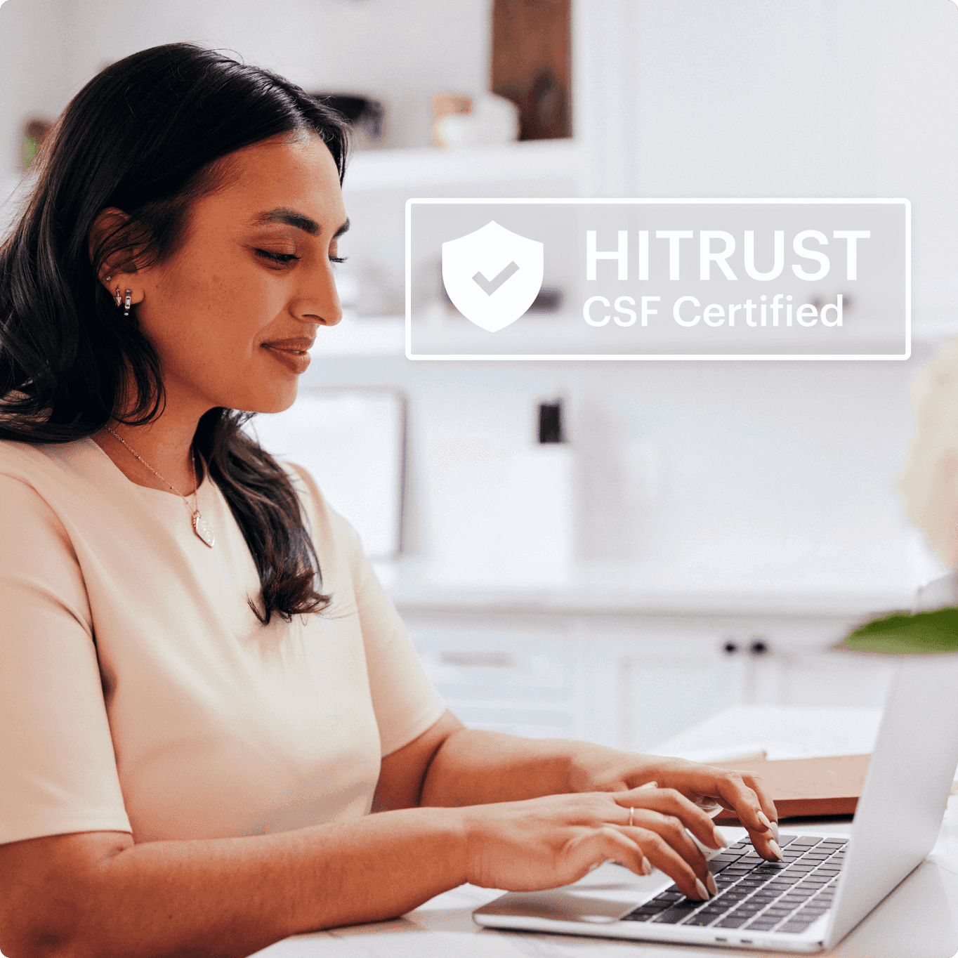 Female therapist using software for occupational therapists viewed on a laptop with badge that says HITRUST CSF Certified
