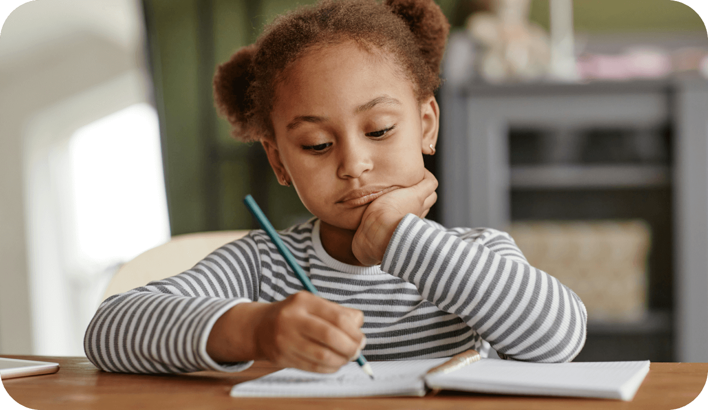 A child sits at a desk with her pencil and fills out the OWLs test