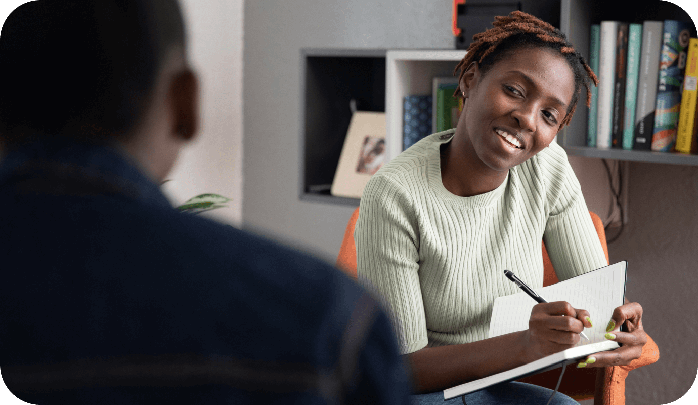 A therapist meets with her male client and writes in her notebook as she considers countertransference in therapy