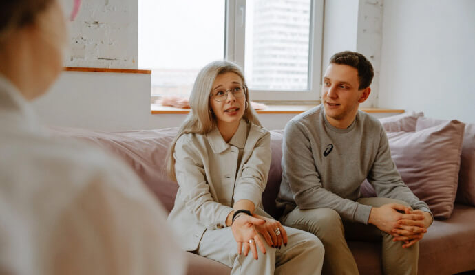 Two adult therapy clients discuss recognizing undiagnosed adult autism with a therapist