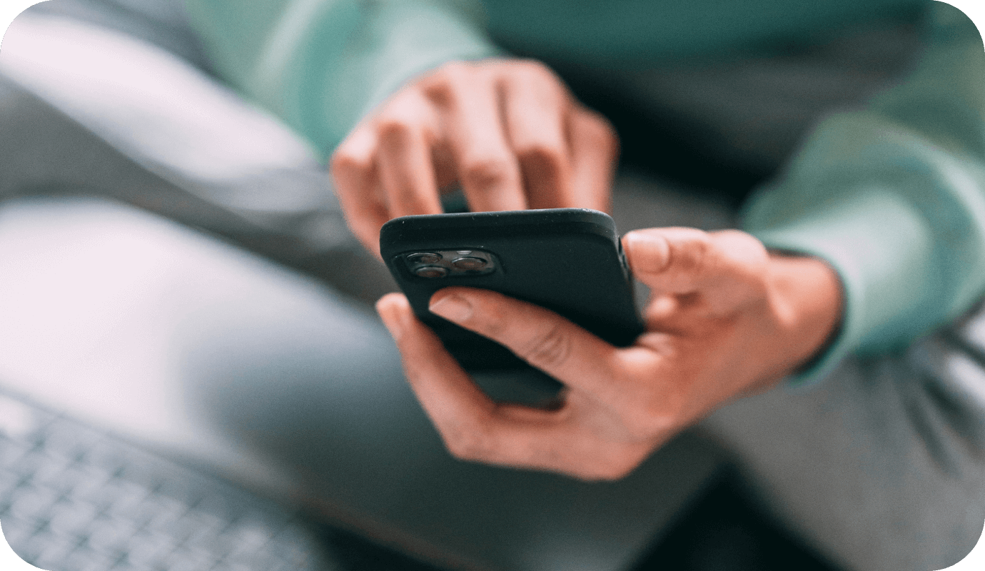 A therapist types on her mobile phone and wonders about the importance of 2FA or two factor authentication or two step verification for online security and HIPAA compliance