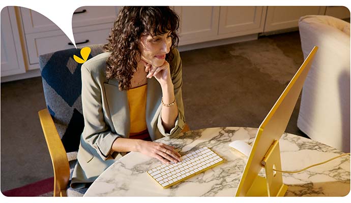 A female therapist types on her computer keyboard as she accesses her AI for therapists session notes