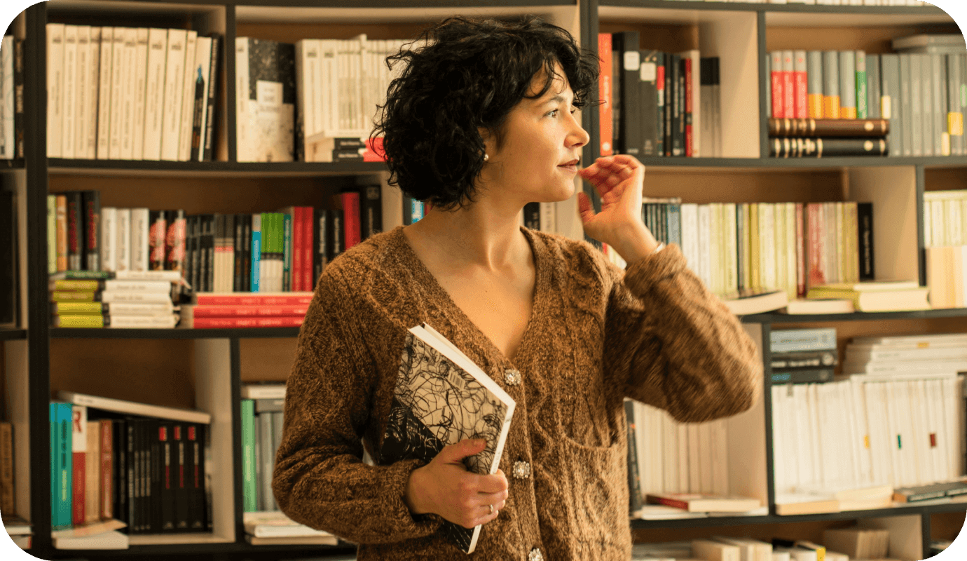 A therapist stands in the library as she contemplates self-publishing her own book