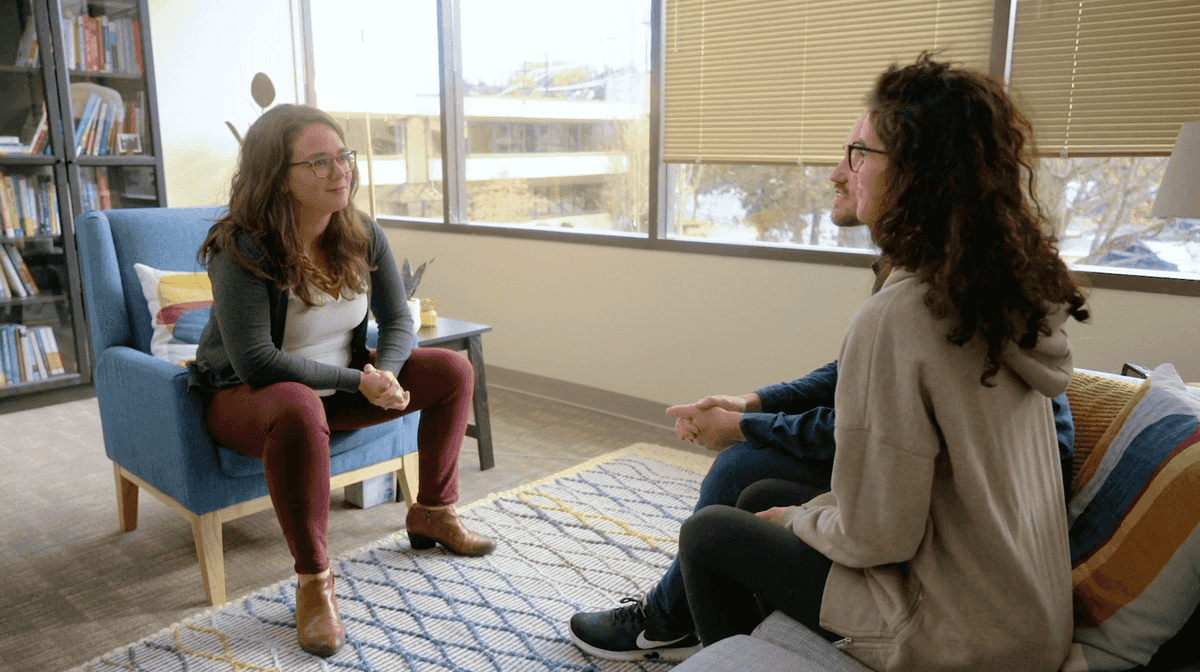 therapist talking with couple during a therapy session